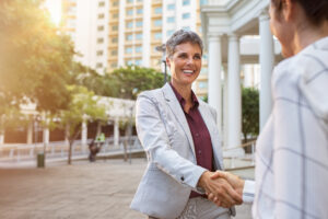A sales rep successfully closing a deal, representing the brand voice of her client.