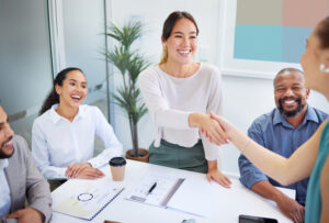 A female employee with professional attitude accepting a job promotion.